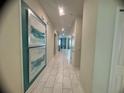 Bright hallway with tile flooring and artwork on display at 1580 Tempo Ln, Davenport, FL 33896
