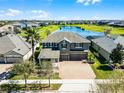 Beautiful home boasts a lake view and lush green landscaping at 16033 Citrus Knoll Dr, Winter Garden, FL 34787