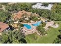 Expansive aerial view of the community pool, clubhouse, and surrounding lush landscaping at 1616 Legacy Park Dr # 1616, Maitland, FL 32751