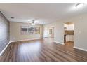 Open-concept living room with wood floors, modern ceiling fan, and plenty of natural light at 1707 Gammon Ln, Orlando, FL 32811