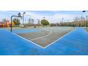 Well-maintained community basketball court with blue and gray surface, ready for play at 2602 Lodi Cir # 105, Kissimmee, FL 34746