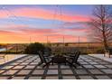 Relaxing backyard featuring a fire pit, string lights, and comfortable seating at 2613 Mead Ave, St Cloud, FL 34771