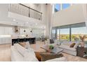 Expansive living room with high ceilings, seamlessly connecting to a modern kitchen and offering abundant natural light at 2613 Mead Ave, St Cloud, FL 34771