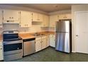 Spacious kitchen features stainless steel appliances and white cabinets at 3188 Owassa Ct, Kissimmee, FL 34746