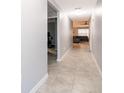 Inviting hallway with tiled floors leading to a living room and additional room, freshly painted in grey at 4418 Blackbird St, Kissimmee, FL 34746