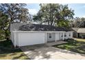 Attractive one-story house featuring attached garage, tidy landscaping, and cozy front porch at 6356 Sleepy Hollow Dr, Orlando, FL 32810
