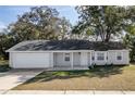 Well-kept single-story home with attached garage and inviting front entrance at 6356 Sleepy Hollow Dr, Orlando, FL 32810