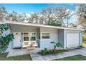 Inviting front porch features seating and a stylish entrance to this charming home at 6408 Ridge Ter, Orlando, FL 32810