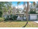 Charming single-story home with lush landscaping, including mature trees, and a well-maintained lawn at 6408 Ridge Ter, Orlando, FL 32810