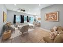 Spacious living room featuring neutral-toned furniture and a ceiling fan, transitioning into the dining area at 6408 Ridge Ter, Orlando, FL 32810