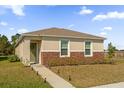 Charming single-story home with a welcoming entrance and a well-maintained lawn at 6895 Botanic Blvd, Harmony, FL 34773