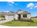 Charming single-story home with well-kept lawn, neutral exterior paint, and two-car garage at 8456 Norwich Way, Mount Dora, FL 32757