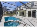 Backyard pool with screened enclosure, hot tub, and outdoor patio, perfect for relaxing and entertaining at 9026 Paolos Pl, Kissimmee, FL 34747