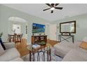 Inviting living room with hardwood floors, a ceiling fan, and lots of natural light at 939 La Salle Ave, Orlando, FL 32803