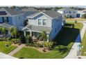 Aerial view of a two-story home with well-maintained landscaping in a residential neighborhood at 9862 Pecan Hickory Way, Orlando, FL 32832