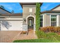 Close-up view of the front entrance, featuring stone accents and an arched doorway at 1208 Patterson Ter, Lake Mary, FL 32746