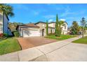 Inviting home featuring a brick driveway, manicured lawn, and well-maintained landscaping at 1208 Patterson Ter, Lake Mary, FL 32746