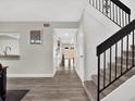 Entryway featuring a staircase with black railings and vinyl flooring at 176 Balfour Dr # 4, Winter Park, FL 32792