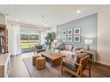 Bright living room featuring neutral tones and a sliding glass door at 2576 Kinsale Ln, Ormond Beach, FL 32174