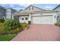 Home with a two car garage and brick driveway at 2606 Pinyonpine Ln, Sanford, FL 32773