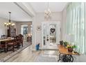 Inviting entryway with decorative front door and chandelier at 2606 Pinyonpine Ln, Sanford, FL 32773