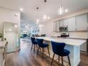 Modern kitchen featuring stainless steel appliances, quartz countertops, and stylish blue bar stools at 2956 Oak Park Way # 45, Orlando, FL 32822