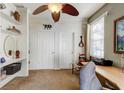 Cozy home office with built-in shelving, a ceiling fan, and neutral decor at 3668 Peppervine Dr, Orlando, FL 32828