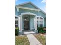 Welcoming front entry with a covered porch, elegant columns, and a view of the front yard at 38 Lakeview Reserve Blvd, Winter Garden, FL 34787