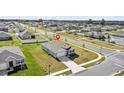 Overhead view of a residential neighborhood with houses, streets, and a community pool at 3842 Rory Oak Circle, Apopka, FL 32703