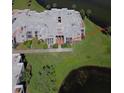 Aerial view of a condominium building with well-maintained landscaping and adjacent to a pond at 536 Orange Dr # 16, Altamonte Springs, FL 32701