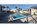 Exterior shot of a large community pool featuring lounge chairs, a fence, and palm trees at 536 Orange Dr # 16, Altamonte Springs, FL 32701