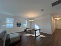 Bright dining room features hardwood floors and a modern chandelier at 5752 Iron Brand Rd, St Cloud, FL 34771