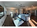 Spacious living room seamlessly connects to the kitchen with an island and stainless steel appliances at 5752 Iron Brand Rd, St Cloud, FL 34771