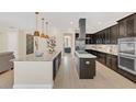 Modern kitchen featuring stainless steel appliances, granite countertops, and an expansive island at 5774 Fulham Pl, Sanford, FL 32771