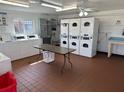 The on-site laundry room features a clean and well-equipped space with multiple washers and dryers at 801 W Lancaster Rd # 92, Orlando, FL 32809