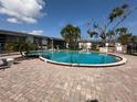 A resort-style pool offers residents relaxation, featuring a brick-paved sundeck and lush landscaping at 801 W Lancaster Rd # 92, Orlando, FL 32809