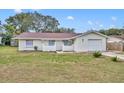 Charming single-story home featuring a well-maintained lawn, attached garage, and freshly painted exterior at 807 Vercelli St, Deltona, FL 32725