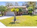 Attractive two-story home with green lawn, mature trees, and an attached two-car garage in a desirable location at 8413 Commander Cv, Winter Park, FL 32792