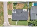 Aerial view of home showing roof, landscaping, driveway, and fenced backyard at 867 N Halifax Dr, Ormond Beach, FL 32176