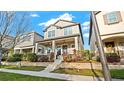 Attractive two-story home featuring a cozy front porch and beautiful landscaping at 9360 Meadow Hunt Way, Winter Garden, FL 34787