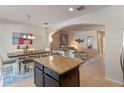 Open concept kitchen with dining area and granite countertops at 9559 Silver Buttonwood St, Orlando, FL 32832