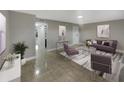 Staged living room with tile floor, modern furniture, neutral walls, and recessed lighting at 1030 Plantation Dr # C6, Kissimmee, FL 34741