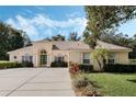 Charming single-story home featuring a spacious driveway, manicured landscaping and a 3-car garage at 126 Seville Chase Dr, Winter Springs, FL 32708