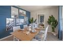 Dining area showcasing a wooden table, decorative lanterns, and nautical-themed artwork at 1336 Hanoverian Dr, Lake Alfred, FL 33850