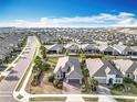 Aerial view showcasing the neighborhood with neatly lined homes and lush green landscaping at 1374 Zeek Ridge St, Clermont, FL 34715