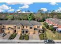 Aerial view of the tan townhouses showcasing the community layout at 1558 Downy Birch Ln, Longwood, FL 32750