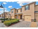 Charming townhouse with paver driveway and lush green landscaping at 1558 Downy Birch Ln, Longwood, FL 32750