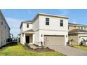 Charming two-story home with attached garage, manicured lawn, and neatly landscaped front yard at 16207 Trinidad Way, Clermont, FL 34714