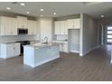 Modern kitchen featuring white cabinets, stainless steel appliances, a center island, and recessed lighting at 16880 Muskgrass Dr, Winter Garden, FL 34787