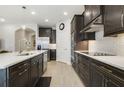 Modern kitchen featuring dark cabinets, stainless steel appliances, and white subway tile backsplash at 17858 Adrift Rd, Winter Garden, FL 34787
